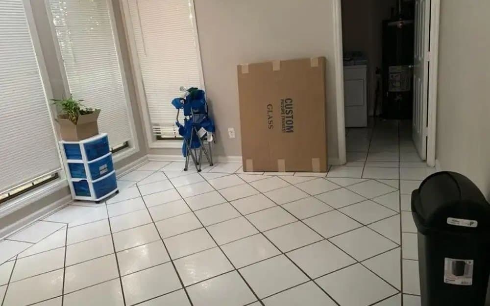 A tiled interior being cleared and cleaned after construction work, with materials boxed up.